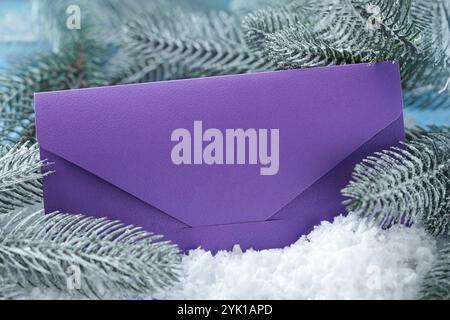 New trend in 2022 color Very Peri. Violet Blank envelope on winter snow background. Template for branding identity. Top view. Stock Photo