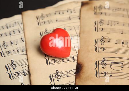Heart figure on musical note sheets, closeup Stock Photo