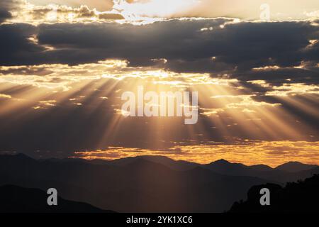 Dramatic sunrise sunbeams breaking through layers of morning clouds.  Photo taken at Rocky Peak Park in Los Angeles County California. Stock Photo