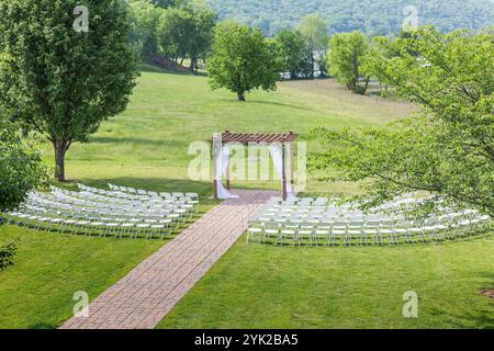Elegant Outdoor Wedding Setup with Floral Decorations and Scenic Backdrop Stock Photo