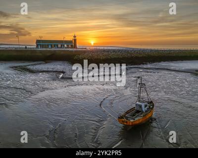 Morecambe Bay, Lancashire, United Kingdom. 12.11.2024 Morecambe Stone Pier Lighthouse built in 1815 pictured at Sunset at low tide. 12th Nov 2024 Stock Photo