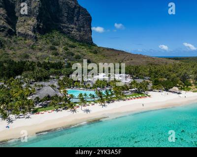 Aerial view of luxury hotel with straw roof villas and pools in ...