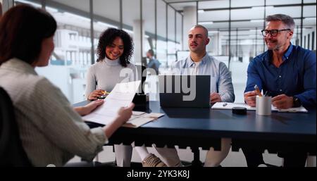 Young Woman Sitting At Interview In Office Stock Photo