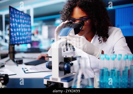 Medical Lab Scientist Woman Doing Research In Laboratory Using Microscope Stock Photo