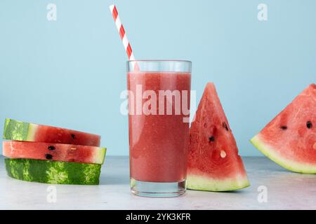 Fresh watermelon juice or smoothie in glasses with watermelon slices on blue background. Refreshing summer drink. Stock Photo