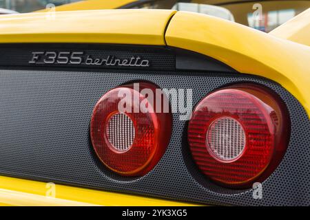 Close up detail of the rear brake lights of a giallo modena yellow Ferrari F355 Berlinetta Italian sports car produced from 1994 to 1999. Stock Photo