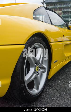 Close up detail of the alloy wheel of a giallo modena yellow Ferrari F355 Berlinetta Italian sports car produced from 1994 to 1999. Stock Photo