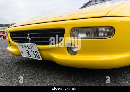 Close up detail of the front grille and headlight of a giallo modena yellow Ferrari F355 Berlinetta Italian sports car produced from 1994 to 1999. Stock Photo
