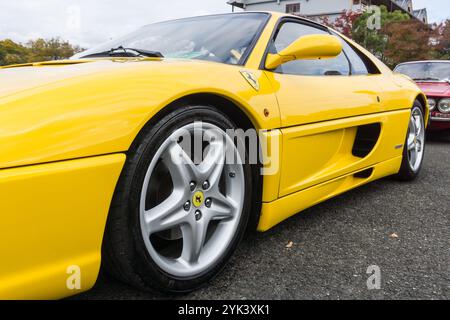 Close up detail of the front left side of a giallo modena yellow Ferrari F355 Berlinetta Italian sports car produced from 1994 to 1999. Stock Photo