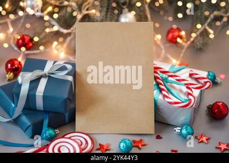 Empty Craft Paper Envelope, Christmas Gifts for Men. Blue Gift box, candy on Christmas background. Gift for husband. Present for him. Mock up Stock Photo