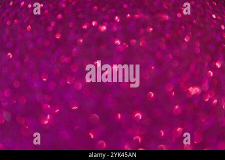 Defocused abstract bokeh background pink purple colored, flare from lights, blurred round bokeh as holiday, celebration wallpaper. Glittering textured Stock Photo
