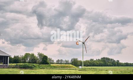 A rural Dutch landscape featuring a small EAZ wind turbine, green ...