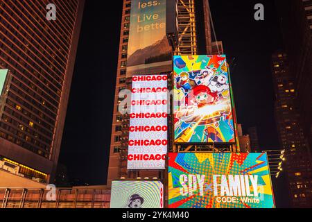 Bright illuminated billboards at night in Times Square featuring Chicago musical and Spy x Family Code White advertisements. New York. USA. Stock Photo