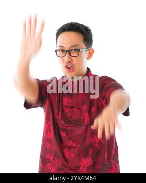 Practicing wushu Southeast Asian Chinese man practicing wushu, isolated on white background Copyright: xZoonar.com/szefeix 1053985426st Stock Photo