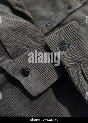Corduroy cuffs close up, dark green khaki velvet shirt sleeves close up, textile, cotton, textured fabric, clothes, sewing, fashion, clothes store Stock Photo