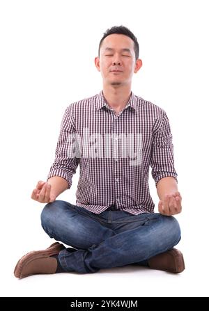 Asian meditation man Calm Asian meditation man in lotus position. Full body sitting isolated over white background. Asian male model. Copyright: xZoon Stock Photo