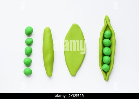 Modelling clay. Craft Plasticine Green Pea. Step by step. Childrens activity in school art lesson and plasticine concept. Stock Photo
