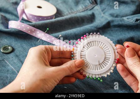 Sewing accessories on jeans background. Use your pin as stitch. Domestic life. Handmade Stock Photo