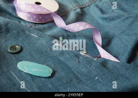 Pins, Chalk, Needles, Tape. Sewing accessories on jeans background. Use your pin as stitch. Domestic life Stock Photo