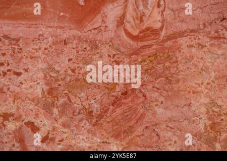 Polished red marble texture featuring unique natural patterns, perfect for wall or floor design. Stock Photo