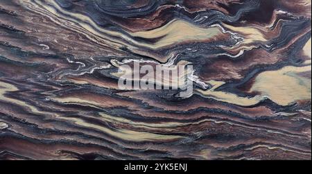 Natural quartzite stone texture featuring swirls of brown, beige, and gray, perfect for decor. Stock Photo