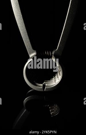 Nutcracker. Close-up of kitchen utensil against black background. portrait format. Stock Photo