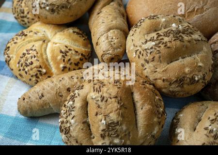 Heap of various bread rolls sprinkled with salt, caraway and sesame. Fresh rustic bread from leavened dough. Assortment of freshly of bakery products Stock Photo