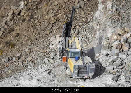 Drilling machine in open cast mining quarry Stock Photo
