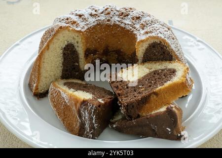 Traditional homemade marble cake. Sliced marble bundt cake on white plate Stock Photo