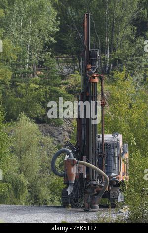 Drilling machine in open cast mining quarry. Mining industry Stock Photo