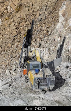 Drilling machine in open cast mining quarry Stock Photo