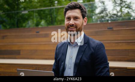 Businessman Caucasian guy middle-aged entrepreneur business man employer freelancer outdoor working online in city male architect real estate agent Stock Photo