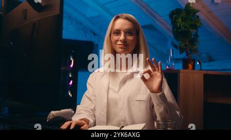 Caucasian business woman smile girl female gamer broker businesswoman night late work office stock market web data on computer screen typing code Stock Photo