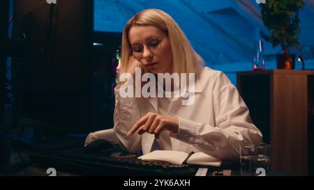 Tired lazy Caucasian businesswoman IT programmer typing keyboard code tech software sleepy exhausted female girl business woman sleep night home Stock Photo