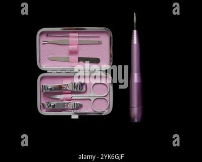 Pink manicure set isolated on black background with copy space. Stock Photo