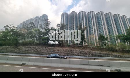 A dense urban landscape in Hong Kong, characterized by towering residential high-rise buildings Stock Photo