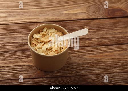 Close up brown paper cup of mille-feuille custard slice cake also known as Napoleon or vanilla slice, on wooden table, high angle view Stock Photo