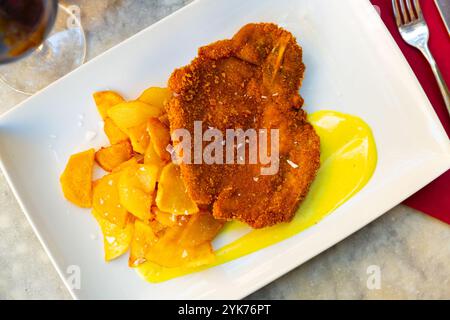 Appetizing breaded beef served with fried potato Stock Photo