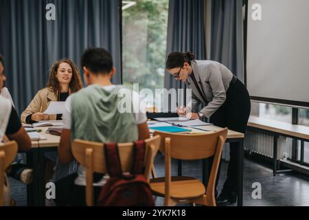 Teacher guiding students during interactive classroom learning session Stock Photo
