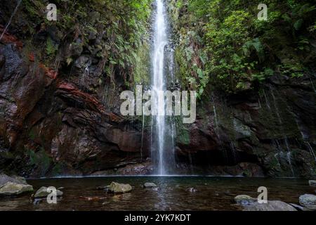 Beautiful waterfall in the middle of a jungle surrounded by foliage, shot in Madeira, Portugal Stock Photo