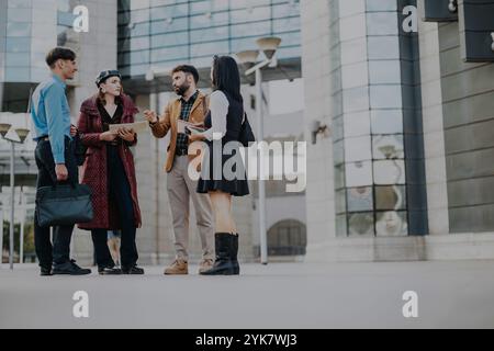 Business professionals having a discussion outside a modern office building Stock Photo