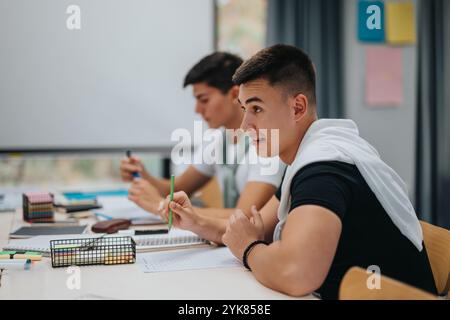 Students in classroom focused on studies and taking notes Stock Photo
