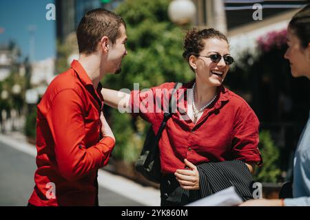 Businesspeople smiling and talking outdoors on a sunny day Stock Photo