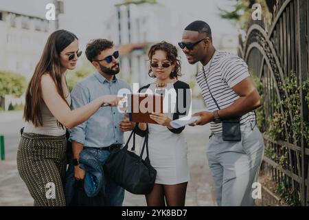 Diverse people collaborating outdoors in urban city environment Stock Photo