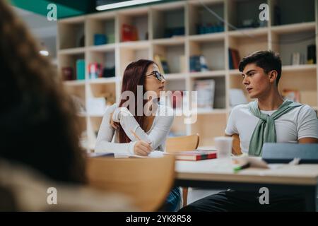 Engaged students participating in classroom discussion setting Stock Photo