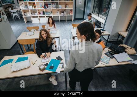 Engaged students learning in a modern classroom environment Stock Photo