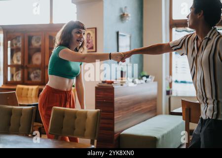 Joyful couple dancing together in a cozy home setting Stock Photo