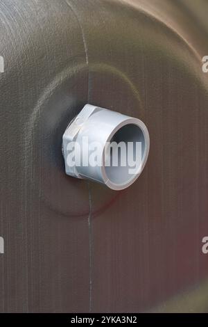 close-up of pvc overflow pipe on black textured water tank, soft focus with copy space Stock Photo