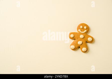 Gingerbread cookie with human shape decoration on yellow background Stock Photo
