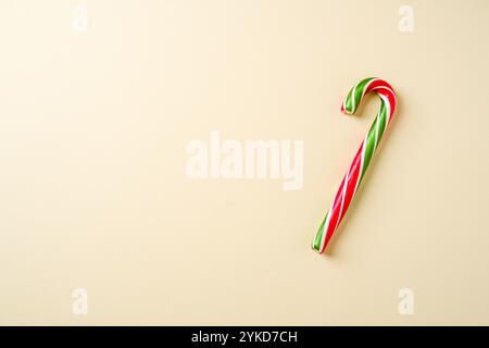 Candy cane in red, green and white on a yellow background Stock Photo